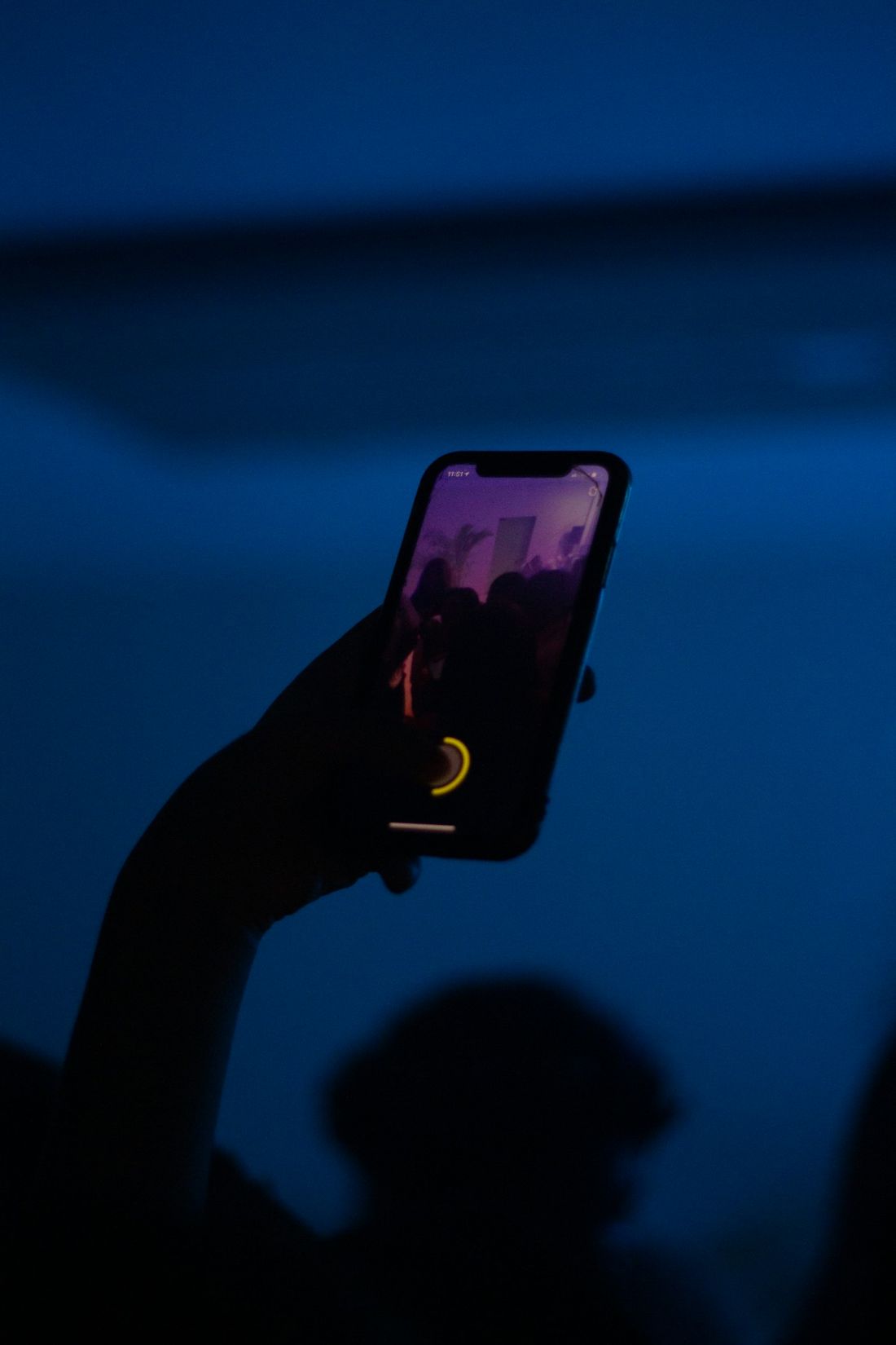 A phone held up in a dark room